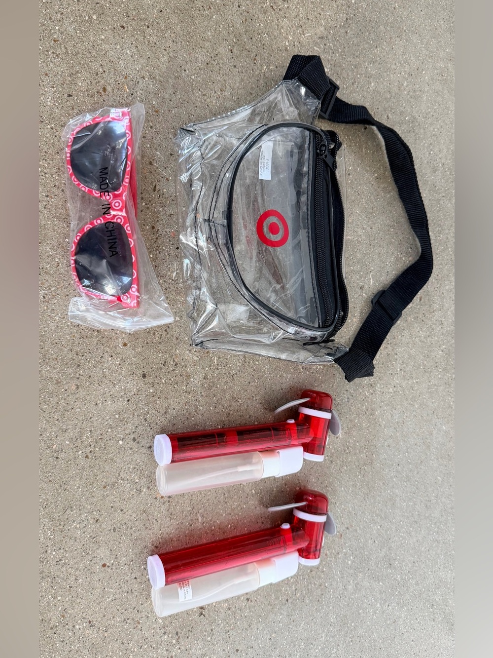 Target Clear Crossbody Bag with Red Logo & Pink Kids Sunglasses and fans